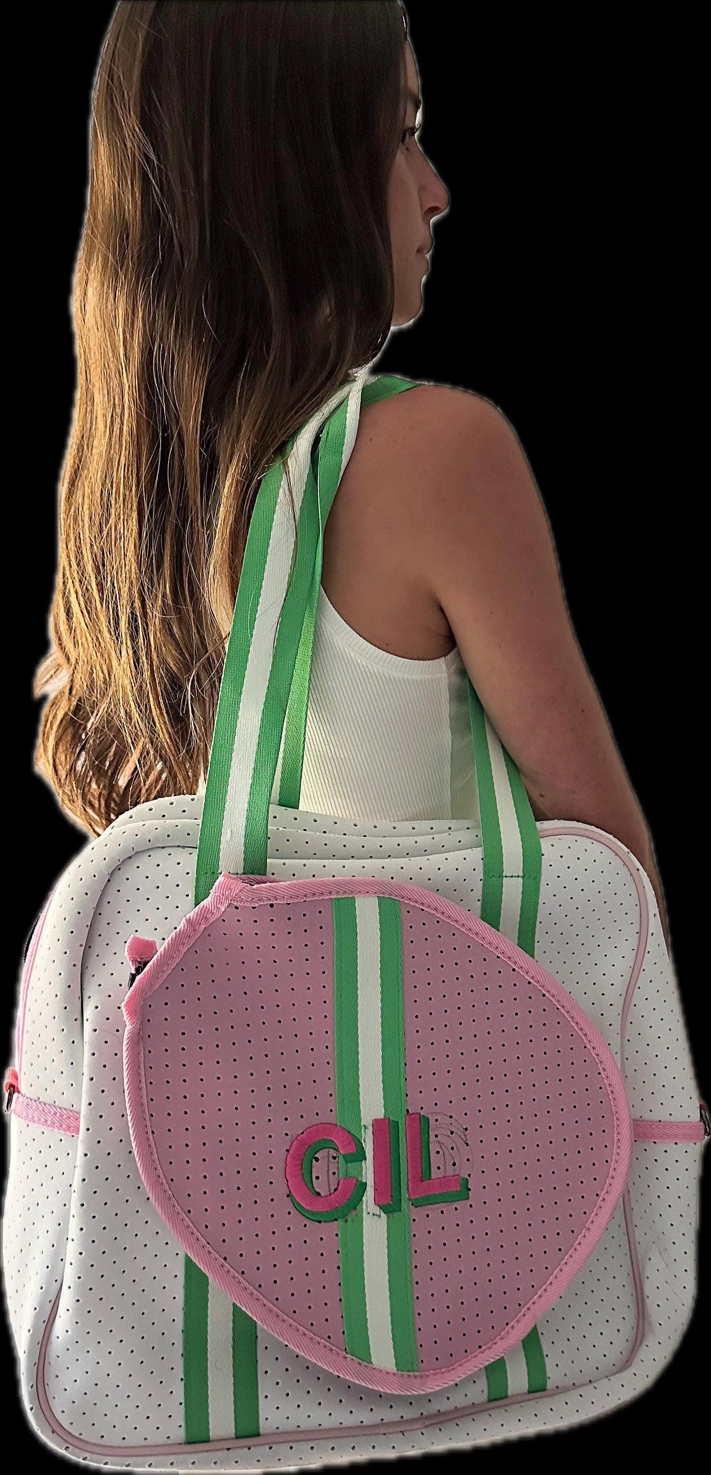 Backpack with green and pink accents and monogram on a transparent background